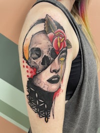a woman with a skull and rose tattoo on her arm